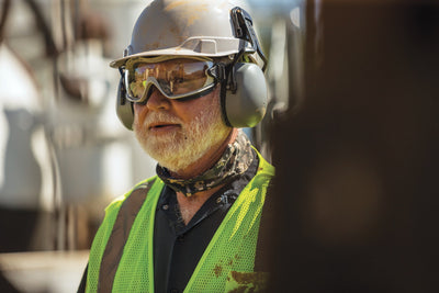 Working wearing Ridgeline Cap Style Hard Hat, Goggle, Cap Mounted Earmuffs, Cooling, and Work Wear