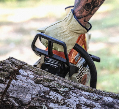 Man wearing Leather Driver while Chainsawing.