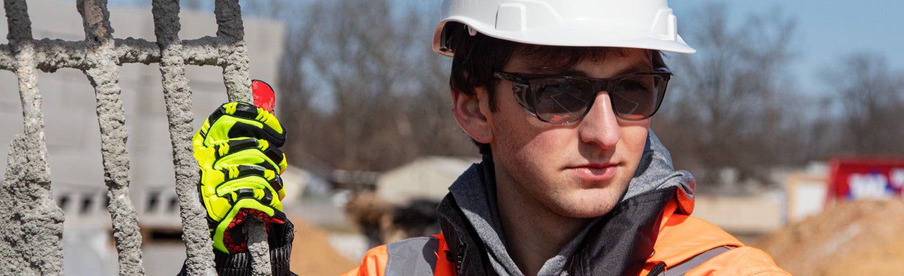 Worker wearing Ridgeline cap style hard hat, Legacy safety eyewear, synthetic leather gloves, and work wear.