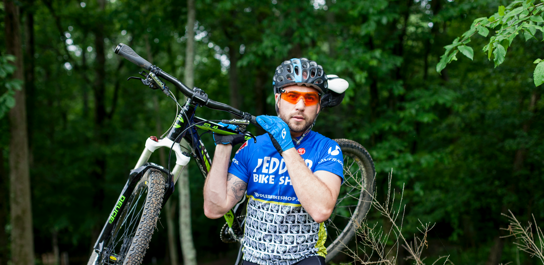 Man wearing Venture Gear DropZone safety eyewear while biking.